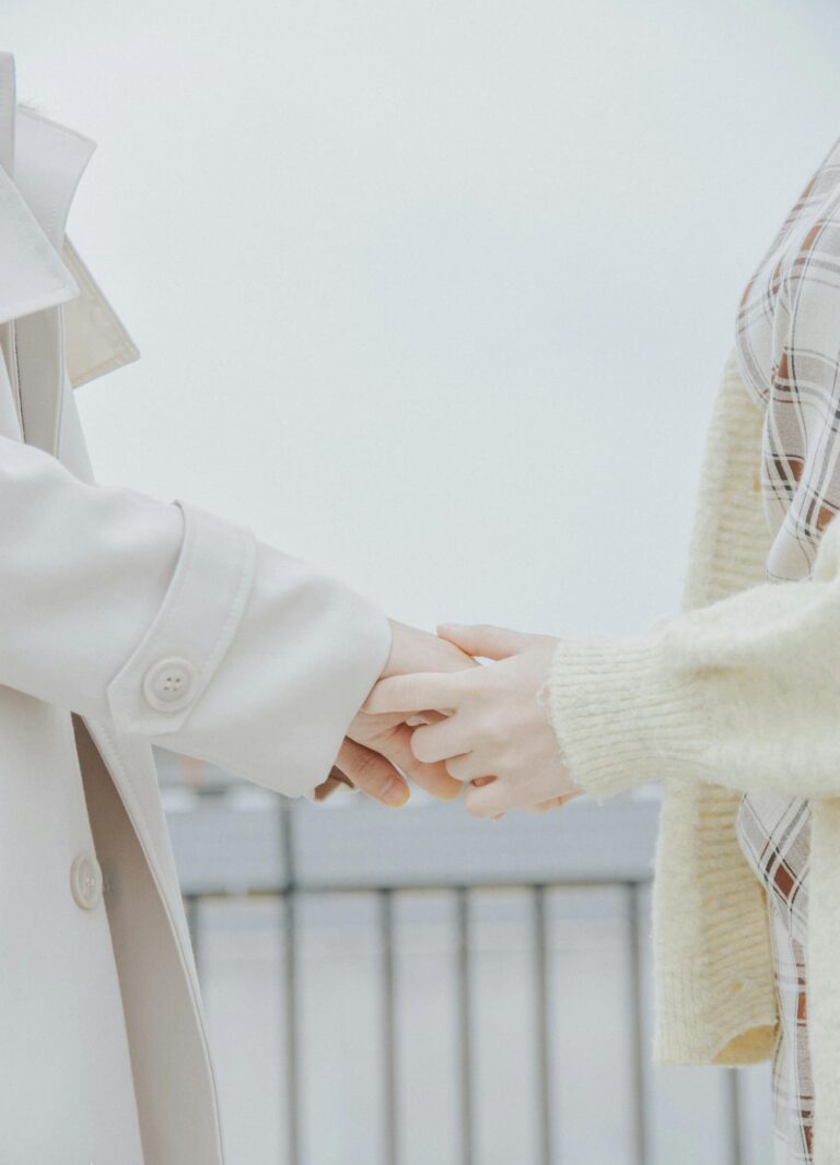 Close-Up Shot of Two People Holding Hands