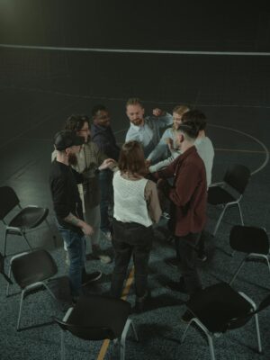 People Standing on Stage in Front of People