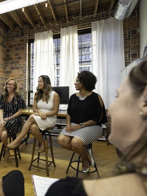 Women Sitting on Chairs Inside a Room